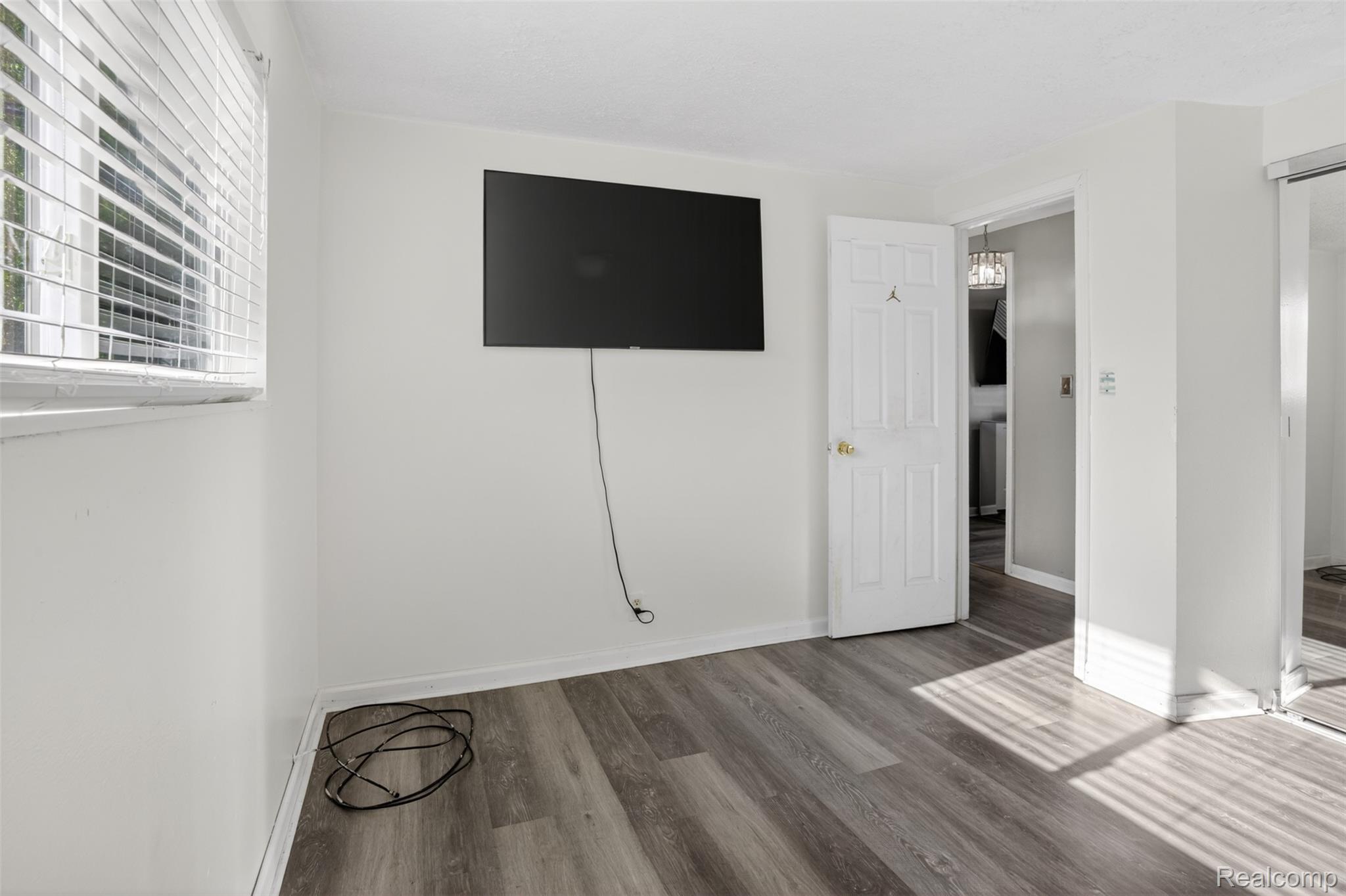 6169 Neff Road Mount Morris, MI 48458 - Photo 23 of 49 Unfurnished bedroom with wood finished floors and baseboards