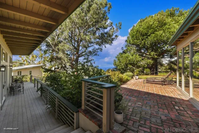 a view of a backyard with sitting area