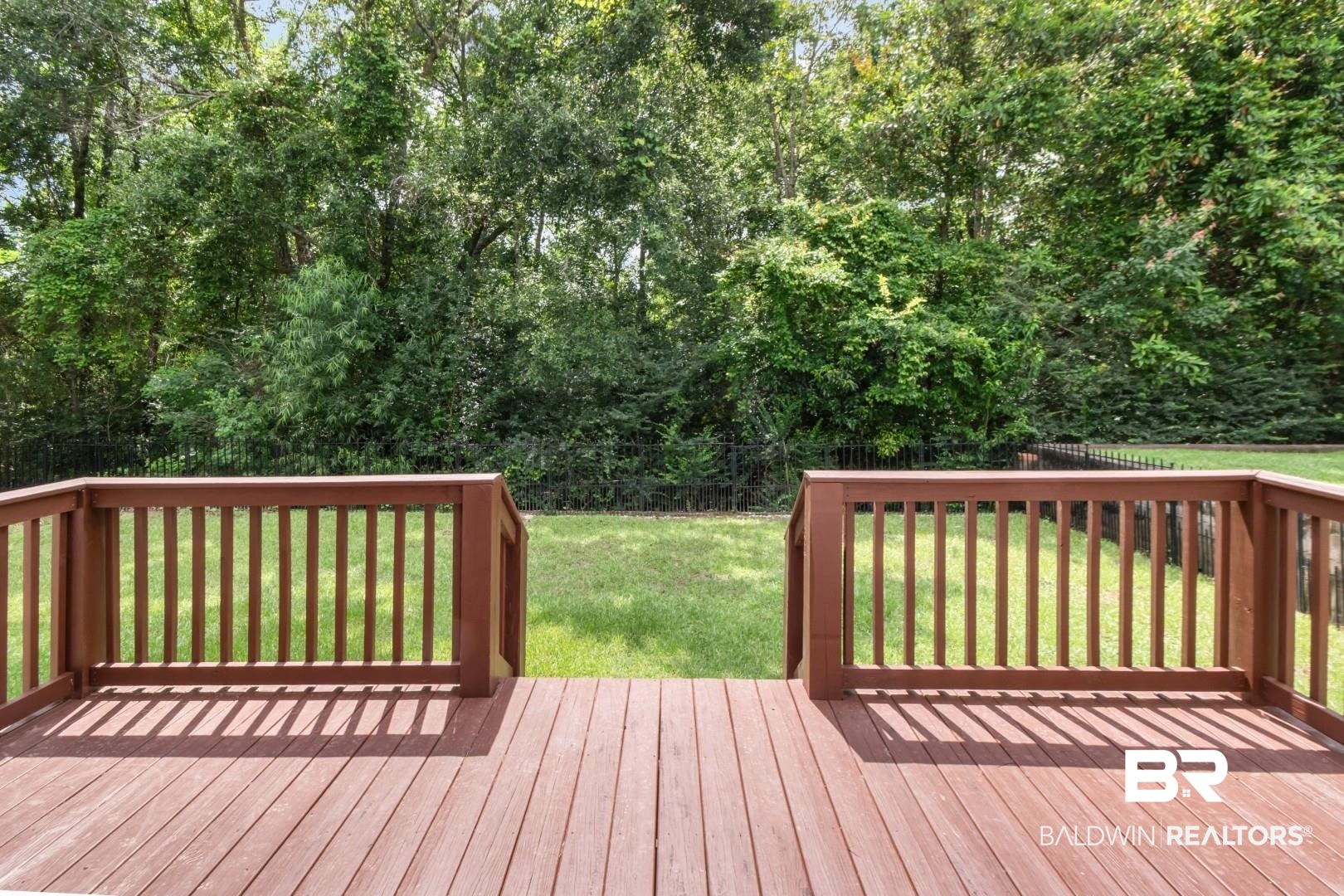 3528 Rue Royal Mobile, AL 36693 - Photo 51 of 53 Expansive wood-finish deck with integrated railing, overlooking a lush green lawn