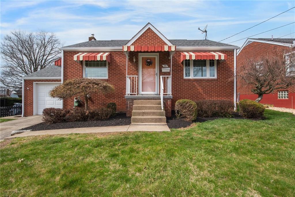208 Eastern Drive Lower Burrell, PA 15068 - Photo 1 of 25 a front view of a house with garden