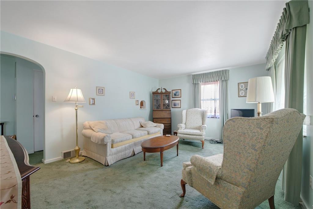 208 Eastern Drive Lower Burrell, PA 15068 - Photo 2 of 25 a living room with furniture and a lamp