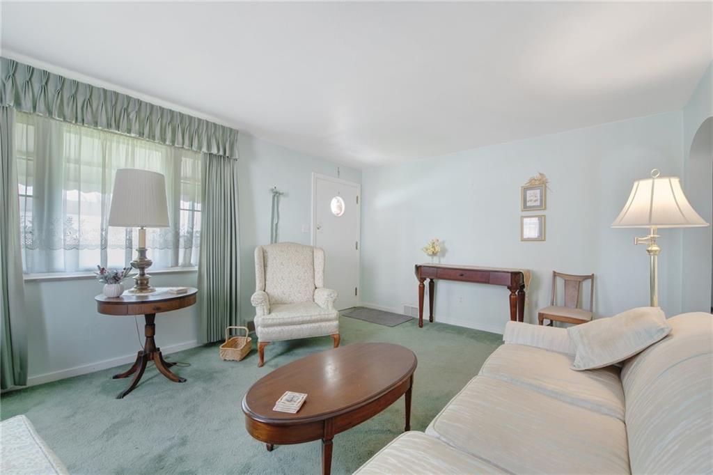 208 Eastern Drive Lower Burrell, PA 15068 - Photo 4 of 25 a living room with furniture a lamp and a table