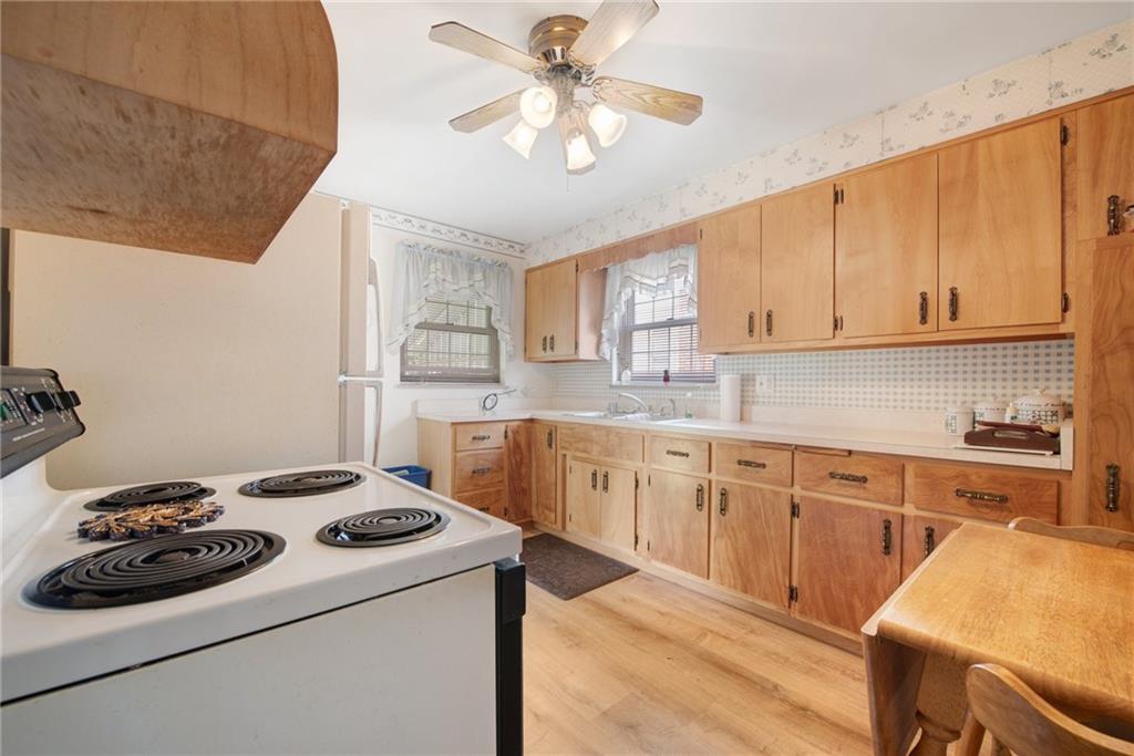 208 Eastern Drive Lower Burrell, PA 15068 - Photo 6 of 25 a kitchen with a white cabinets and appliances