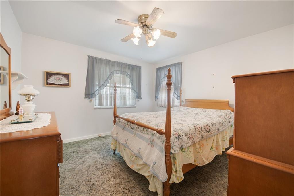 208 Eastern Drive Lower Burrell, PA 15068 - Photo 9 of 25 a bed room with a bed and a chandelier