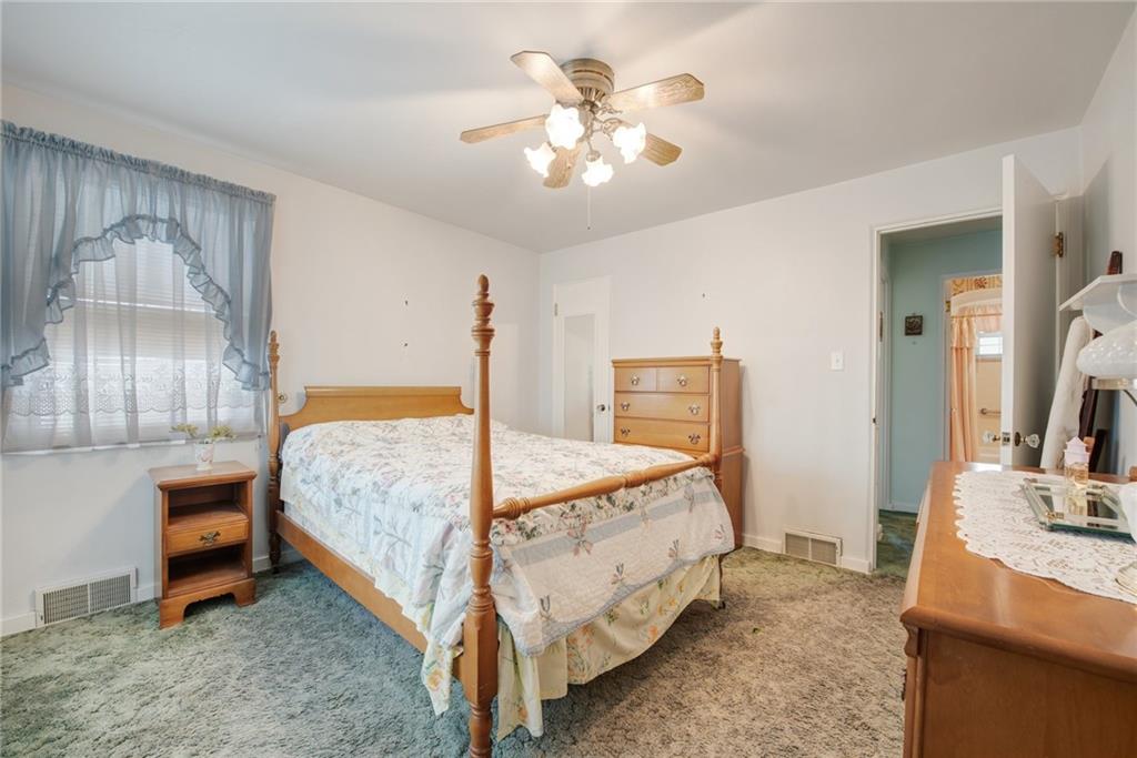 208 Eastern Drive Lower Burrell, PA 15068 - Photo 10 of 25 a bedroom with a bed and a chandelier