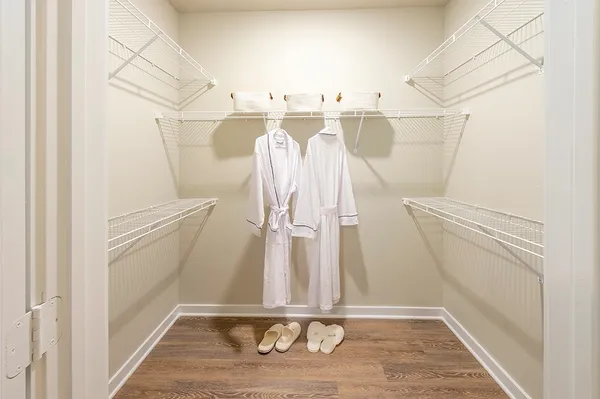 a view of walk in closet with empty racks