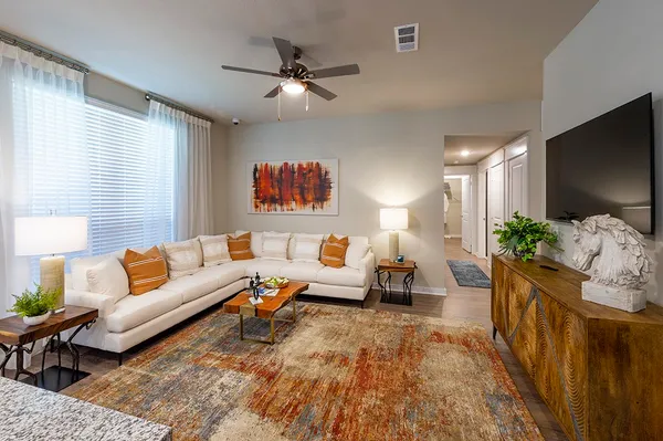 a living room with furniture and a flat screen tv