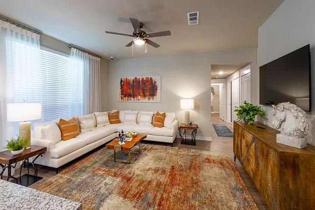 a living room with furniture and a flat screen tv