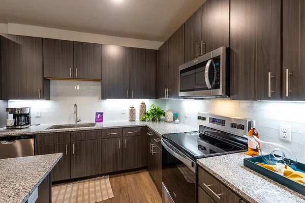 a kitchen with a sink a stove and cabinets
