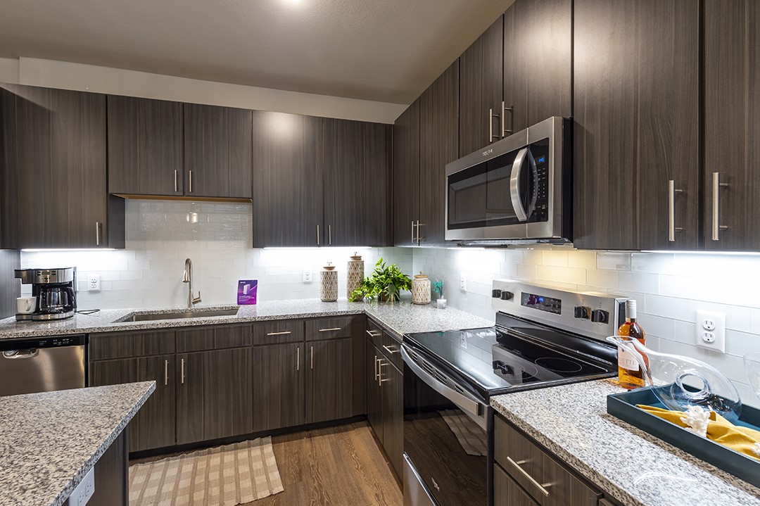 30020 Creekside Ter Drive, Unit 8203 Spring, TX 77386 - Photo 5 of 29 a kitchen with a sink a stove and cabinets
