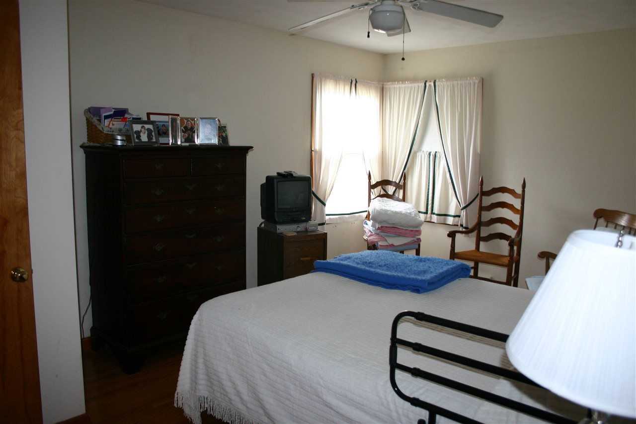86 Fadley Road Weyers Cave, VA 24486 - Photo 17 of 21 a bedroom with a bed and a chandelier
