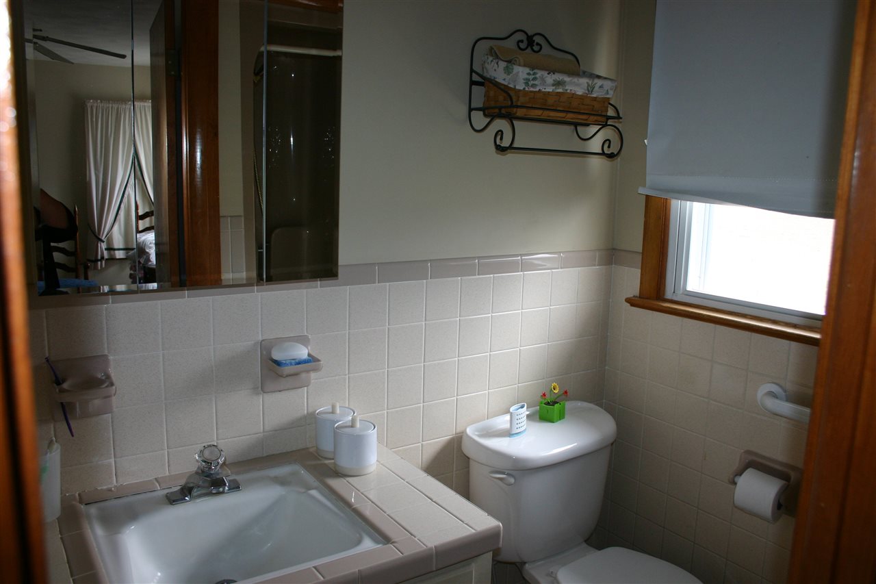 86 Fadley Road Weyers Cave, VA 24486 - Photo 18 of 21 a bathroom with a sink mirror and toilet
