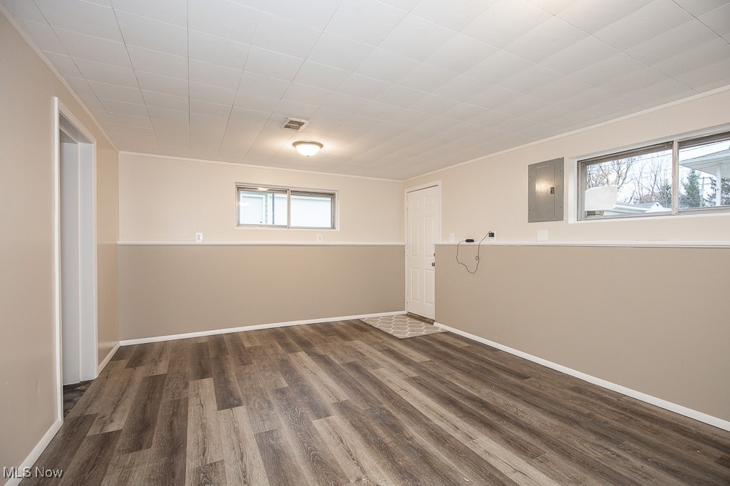 4357 Valleyside Road Cleveland, OH 44135 - Photo 19 of 26 Unfurnished room with electric panel, dark hardwood / wood-style flooring, and a healthy amount of sunlight