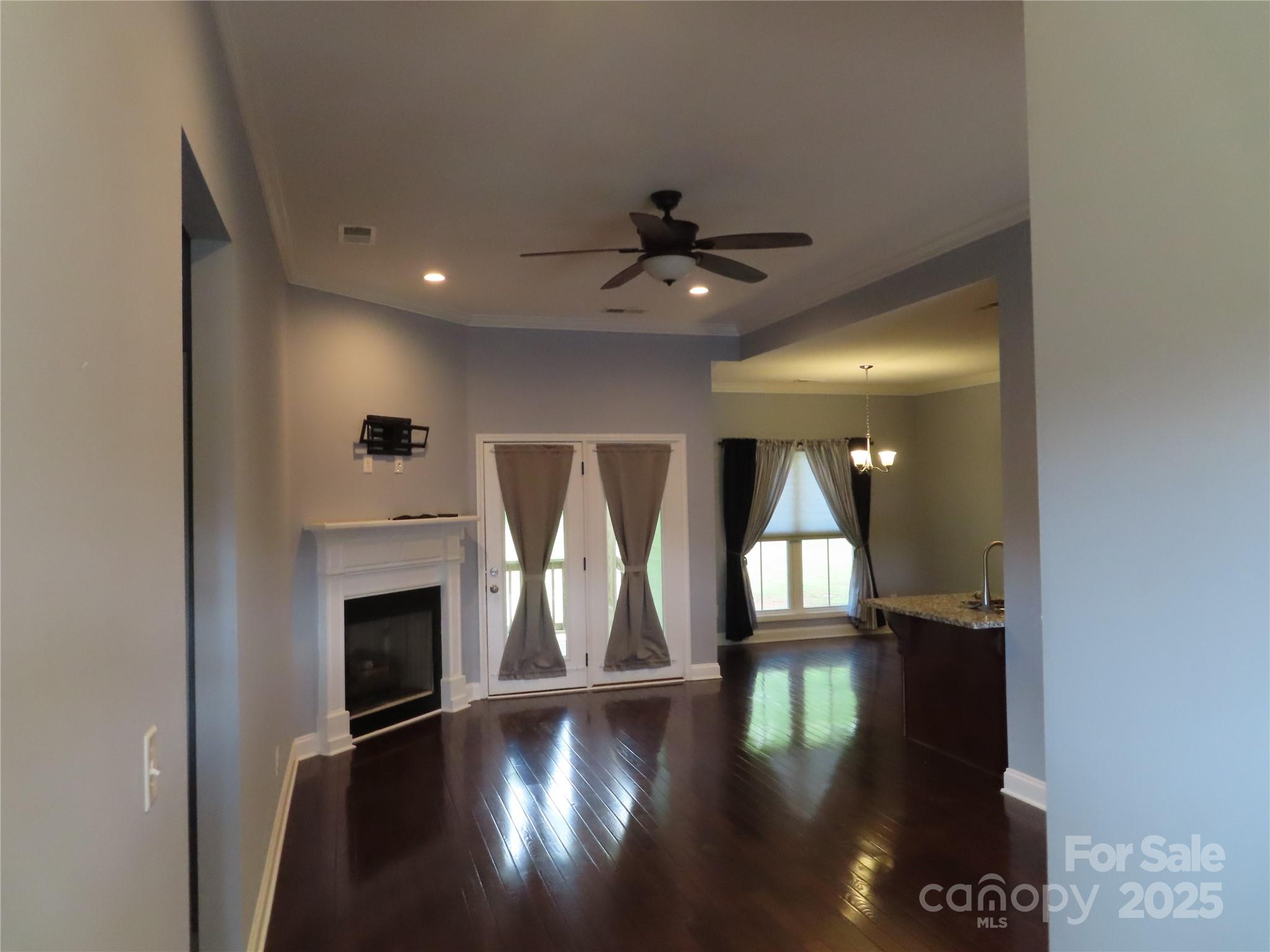 2127 Cedar Road York, SC 29745 - Photo 6 of 23 a view of an empty room with wooden floor and a fireplace