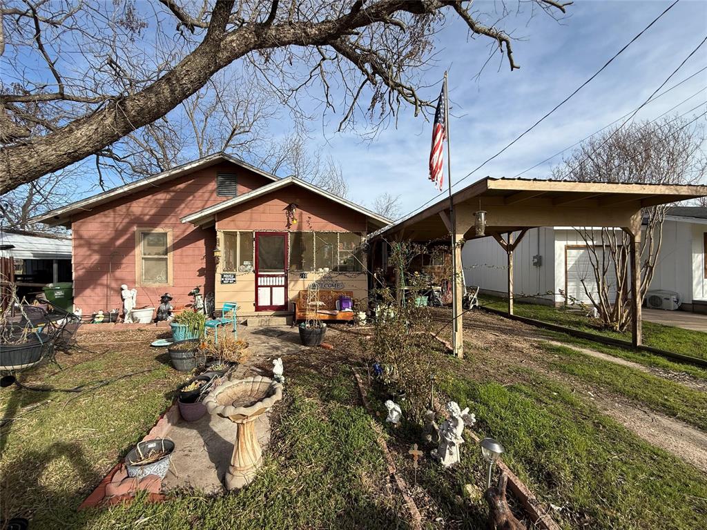 710 Whitney Street Morgan, TX 76671 - Photo 21 of 23 Rear view of house featuring a yard