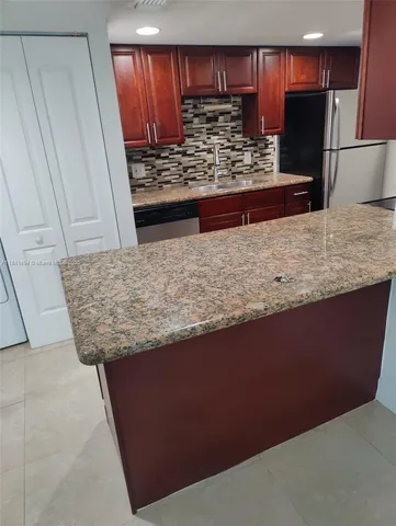 a view of kitchen island with cabinets