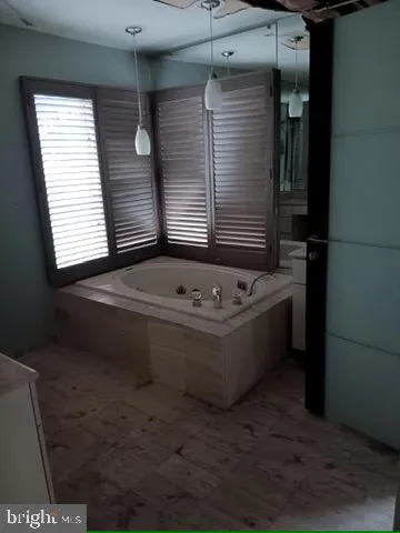 a bathroom with a bathtub and window