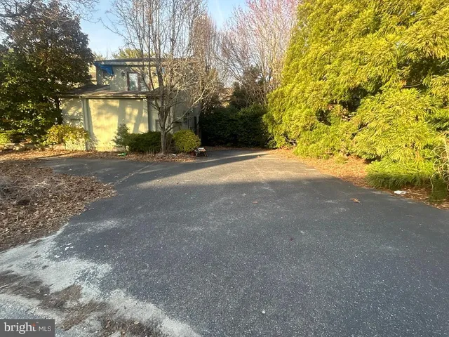 a view of a house with a yard and garage