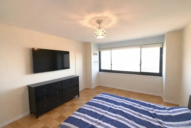 a bedroom with a bed and a flat screen tv