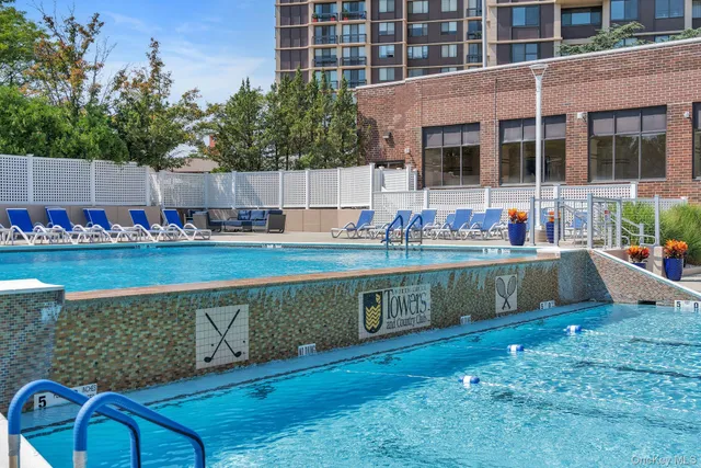 a swimming pool with outdoor seating and yard