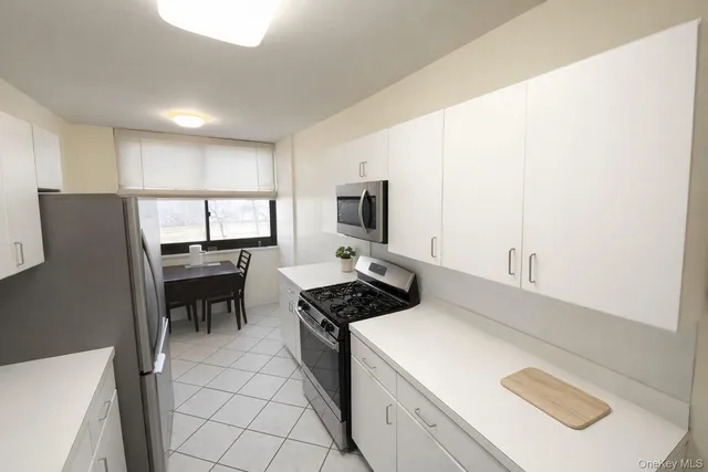 a kitchen that has a cabinets and a stove top oven