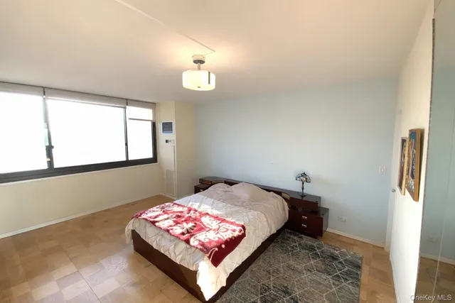 a bedroom with a bed window and wall painting