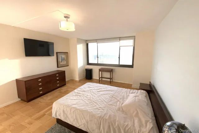 a bedroom with a bed and a flat screen tv