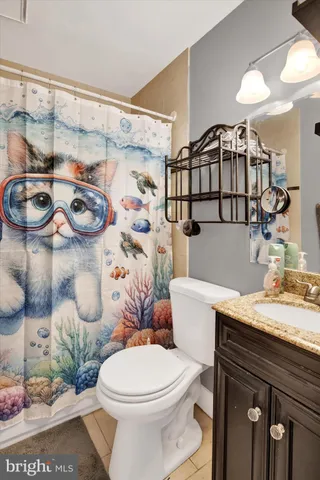 a white toilet sitting next to a bathroom sink