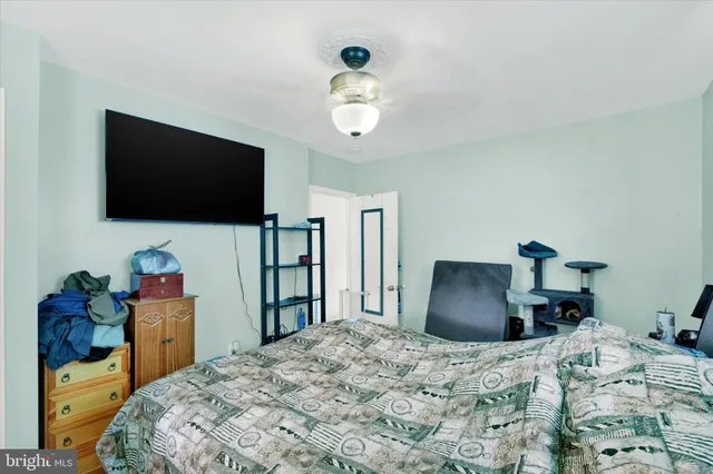 a bedroom with a bed and a flat screen tv