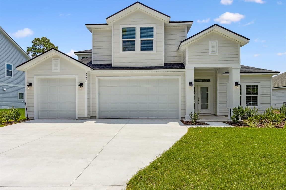 96088 Pirates Bluff Road Yulee, FL 32097 - Photo 1 of 25 front view of a house with a yard