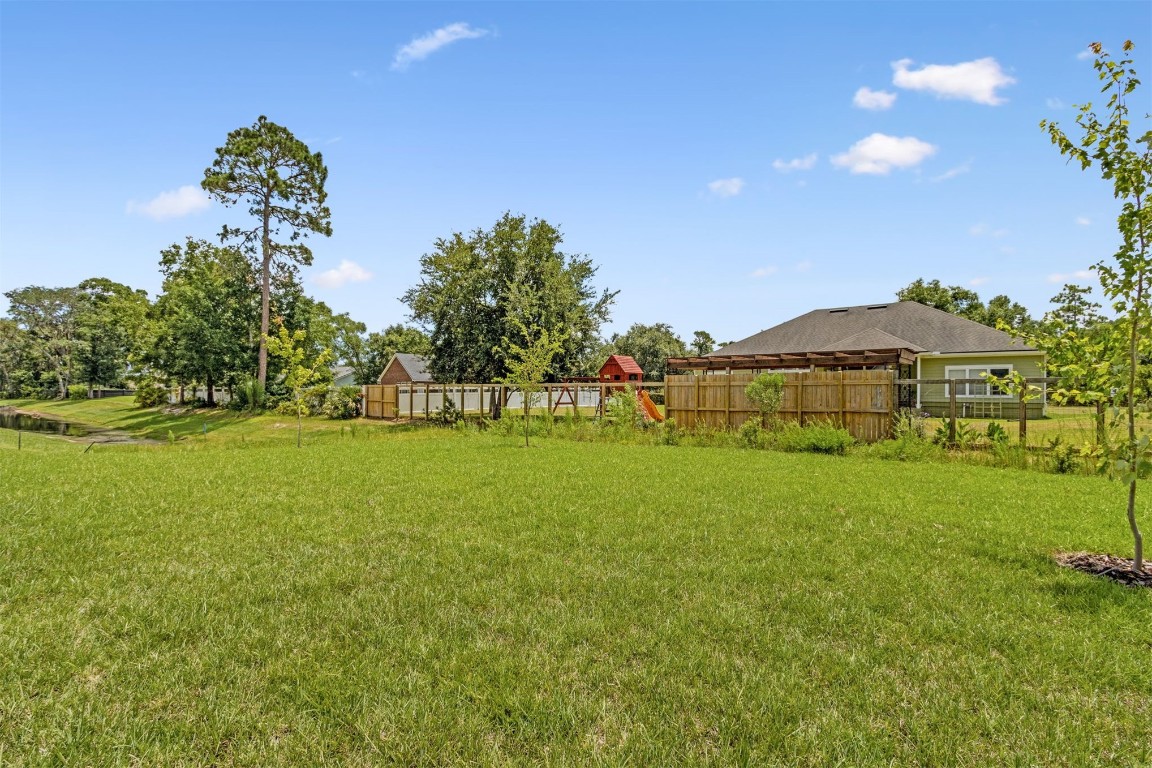 96088 Pirates Bluff Road Yulee, FL 32097 - Photo 23 of 25 a view of outdoor space with garden and trees
