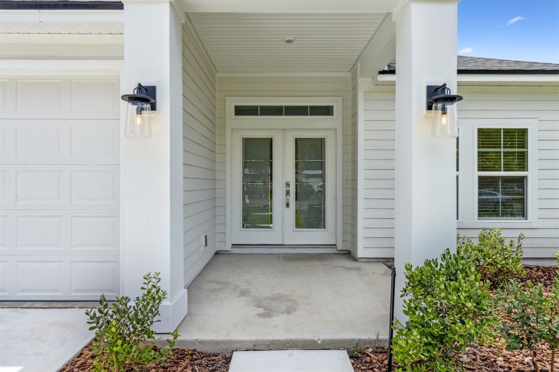 96088 Pirates Bluff Road Yulee, FL 32097 - Photo 6 of 25 front view of a brick house with a large window