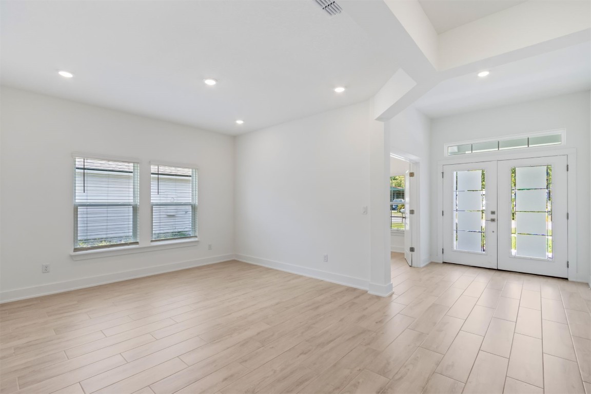 96088 Pirates Bluff Road Yulee, FL 32097 - Photo 8 of 25 an empty room with wooden floor and windows