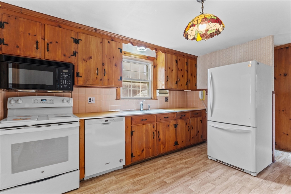 9 Pershing Road Salem, MA 01970 - Photo 11 of 42 a kitchen with a refrigerator stove and microwave