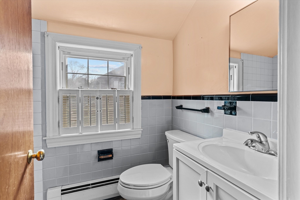 9 Pershing Road Salem, MA 01970 - Photo 20 of 42 a bathroom with a sink a toilet and a window