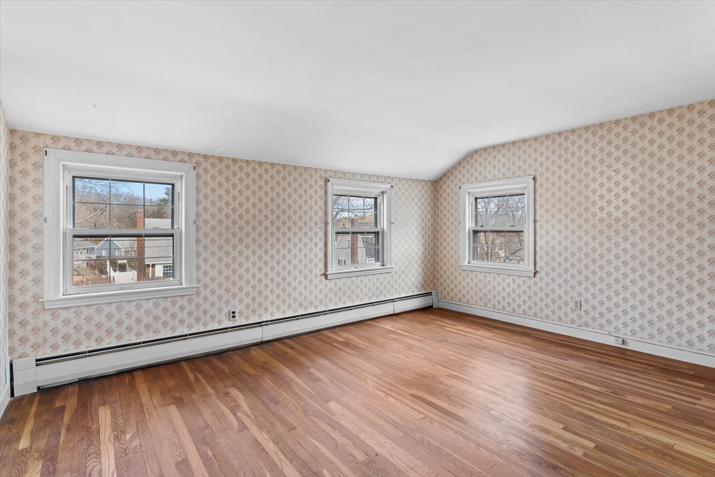 9 Pershing Road Salem, MA 01970 - Photo 26 of 42 a view of an empty room with wooden floor and a window
