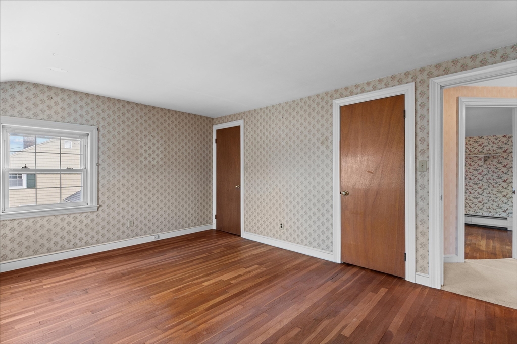 9 Pershing Road Salem, MA 01970 - Photo 27 of 42 an empty room with wooden floor and windows