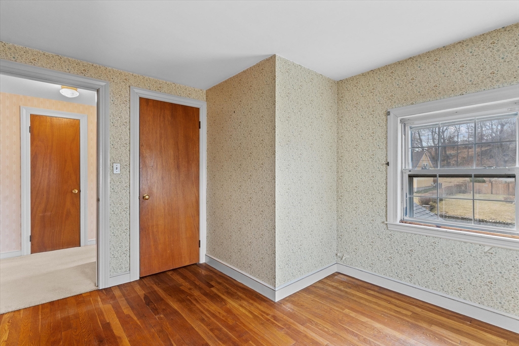9 Pershing Road Salem, MA 01970 - Photo 29 of 42 a view of an empty room with window and wooden floor