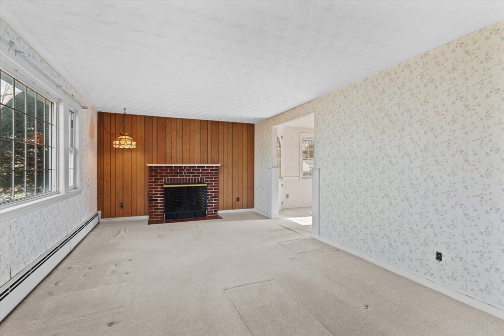9 Pershing Road Salem, MA 01970 - Photo 4 of 42 a view of a livingroom with a fireplace and window