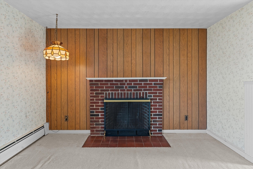 9 Pershing Road Salem, MA 01970 - Photo 5 of 42 a living room with a fireplace