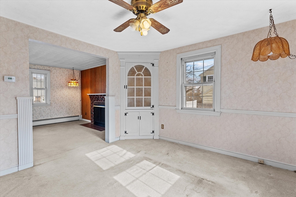 9 Pershing Road Salem, MA 01970 - Photo 9 of 42 an empty room with windows and ceiling fan