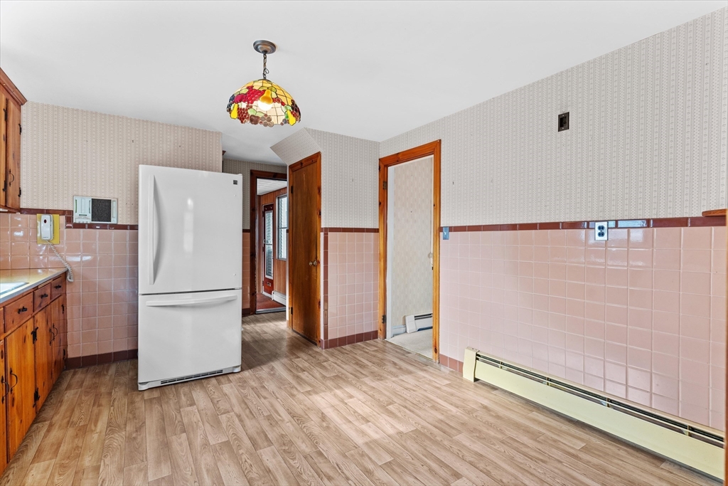 9 Pershing Road Salem, MA 01970 - Photo 10 of 42 a white refrigerator freezer sitting inside of a kitchen