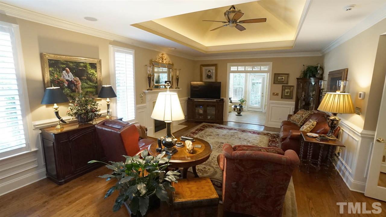 1900 Torrington Street Raleigh, NC 27615 - Photo 3 of 30 Open spacious family room, abundance of light, plantation shutters throughout, intricate molding and attention to detail. Fireplace with marble surround, gas logs w/ fan control. Tray ceiling w/ recessed lights & fan