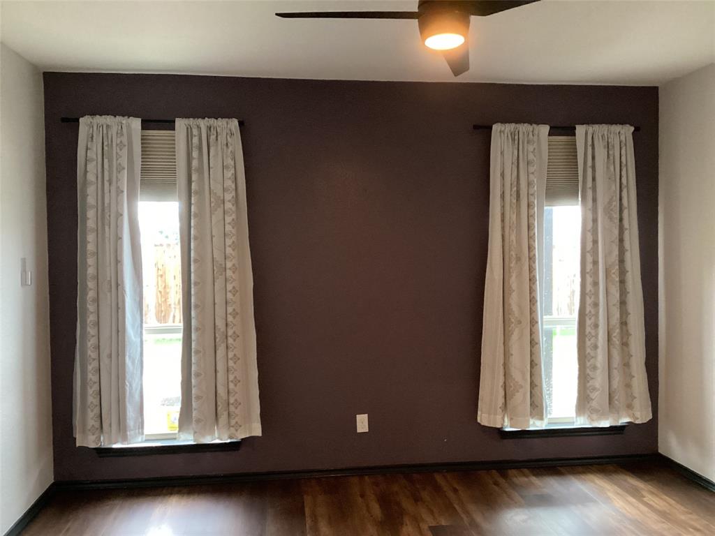 10320 Point Lobos Trail Fort Worth, TX 76177 - Photo 14 of 33 Room featuring wood-finish flooring, a ceiling fan with integrated lighting, and two windows