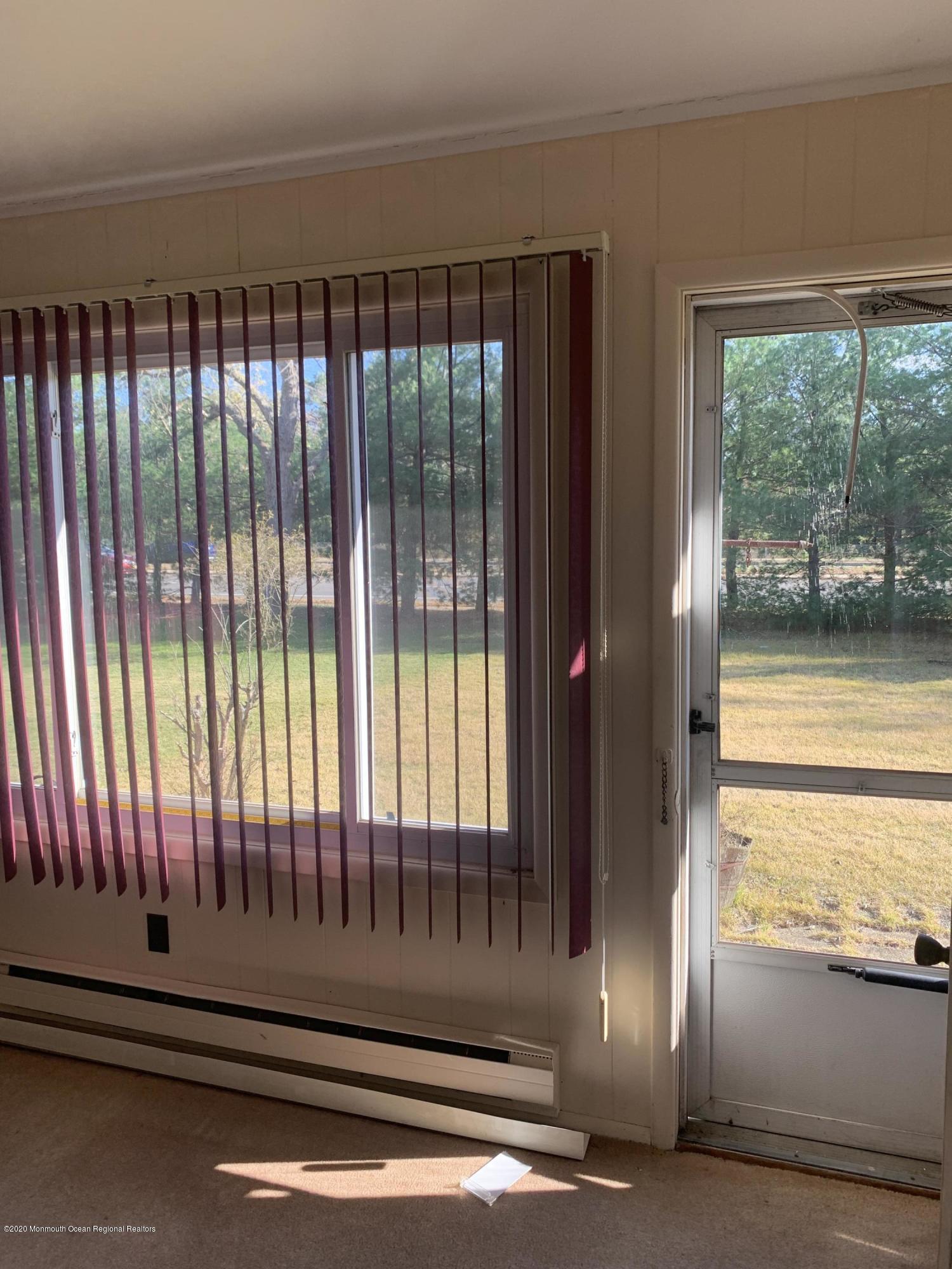 129 Georgetown Road Toms River, NJ 08757 - Photo 5 of 15 a view of a porch with a floor to ceiling window