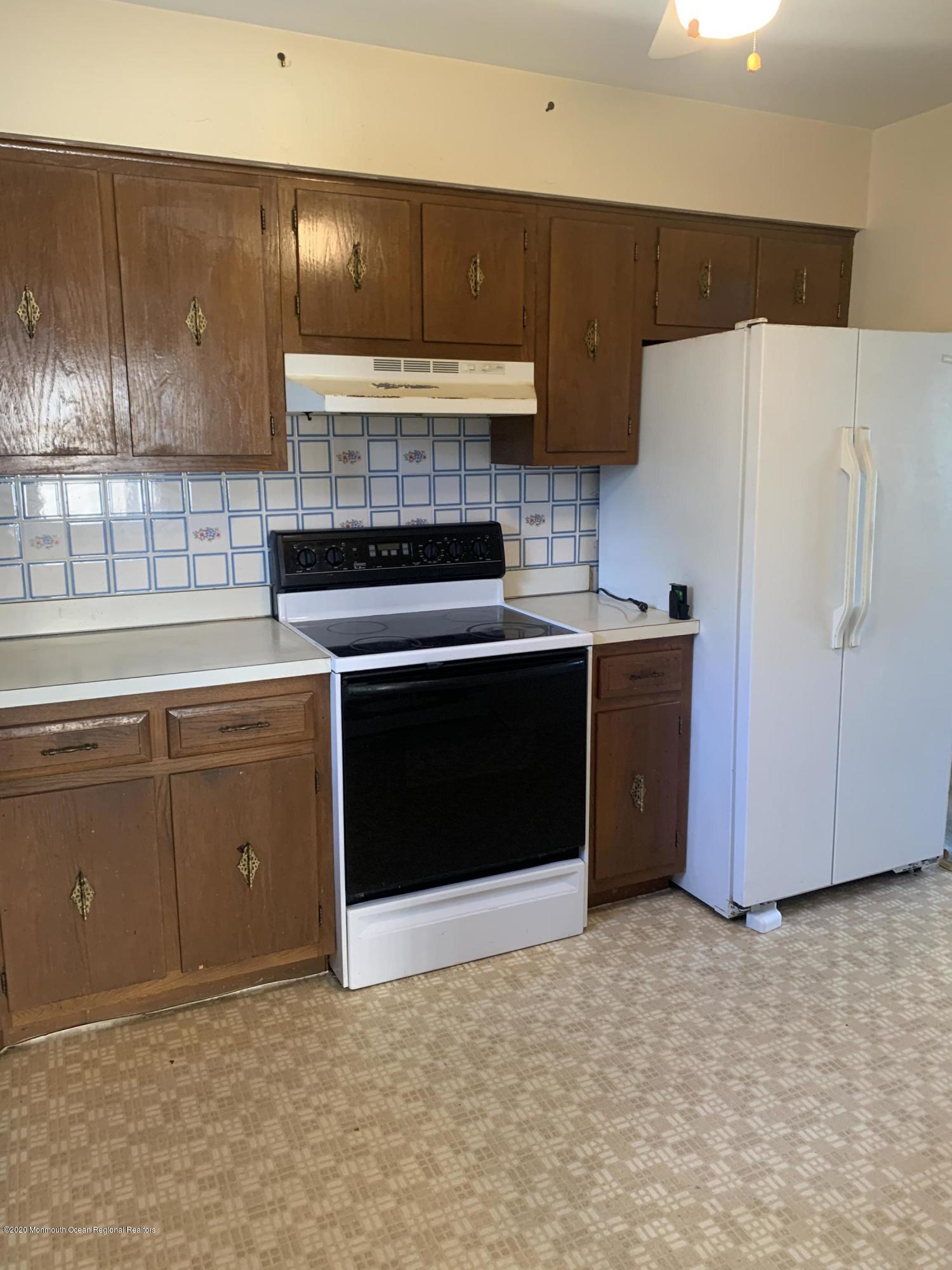129 Georgetown Road Toms River, NJ 08757 - Photo 6 of 15 a kitchen with a stove a sink and a refrigerator