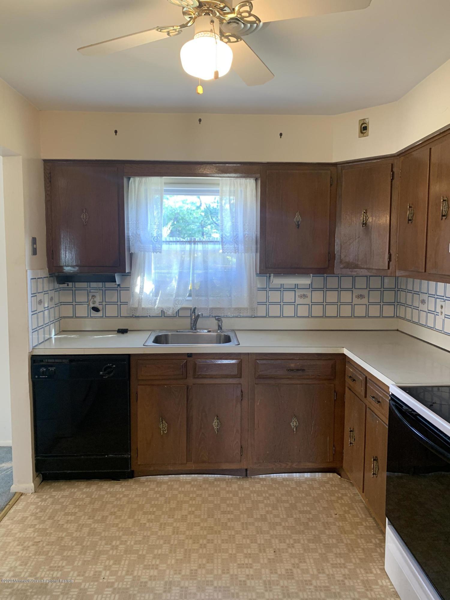129 Georgetown Road Toms River, NJ 08757 - Photo 7 of 15 a kitchen with stainless steel appliances granite countertop a sink and cabinets