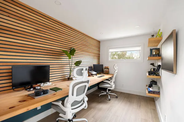 a view of a workspace with furniture and a window