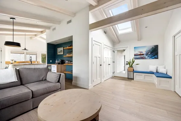 a living room with furniture and view of kitchen