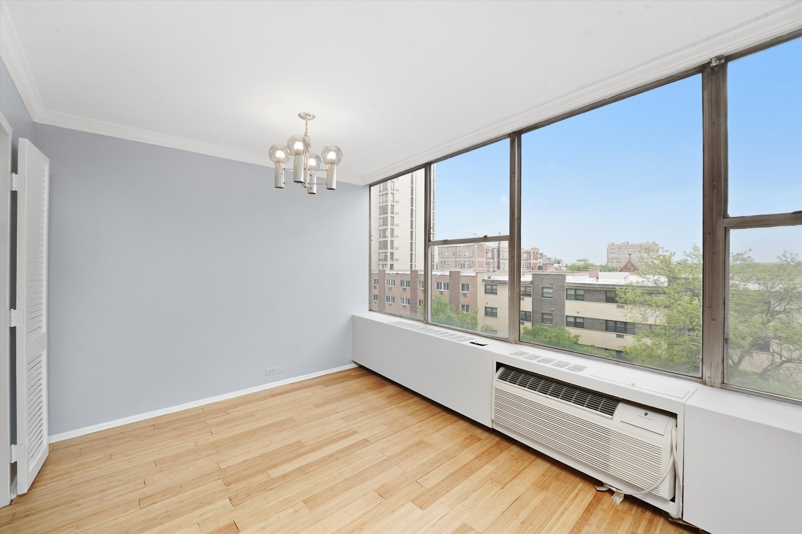 5757 North Sheridan Road, Unit 5J Chicago, IL 60660 - Photo 12 of 44 an empty room with wooden floor and windows